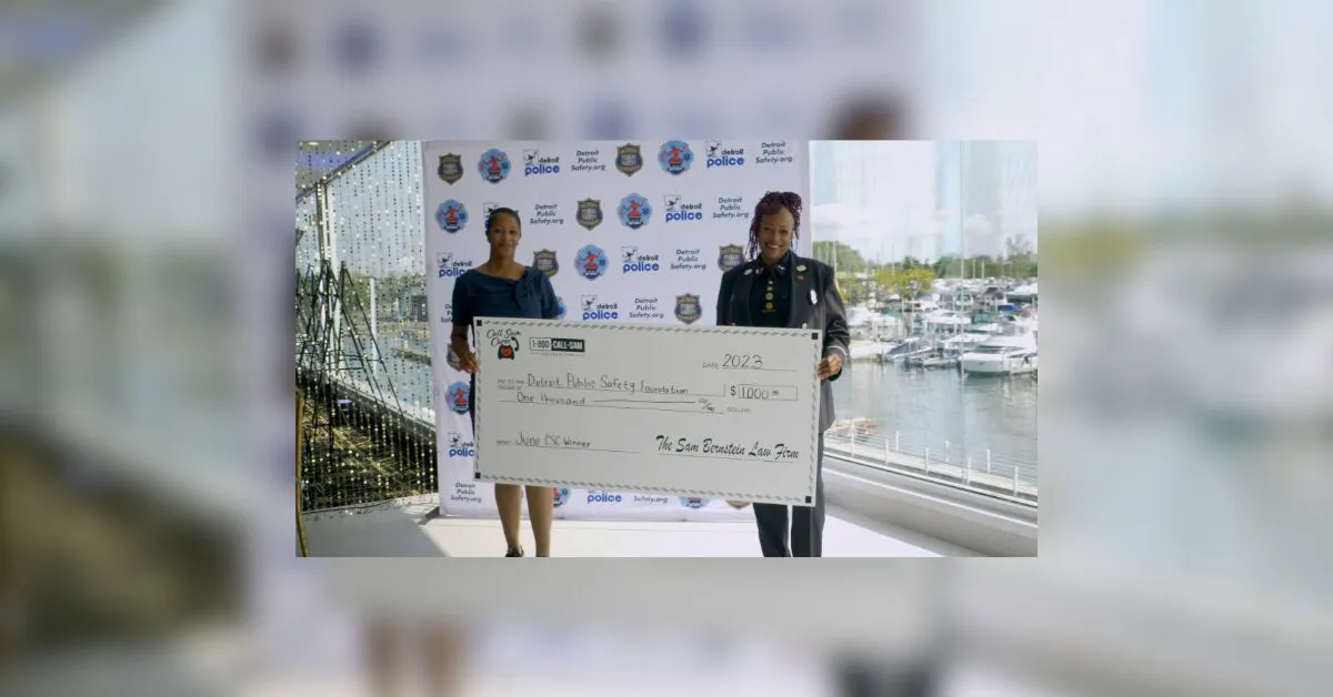2 women holding large format check