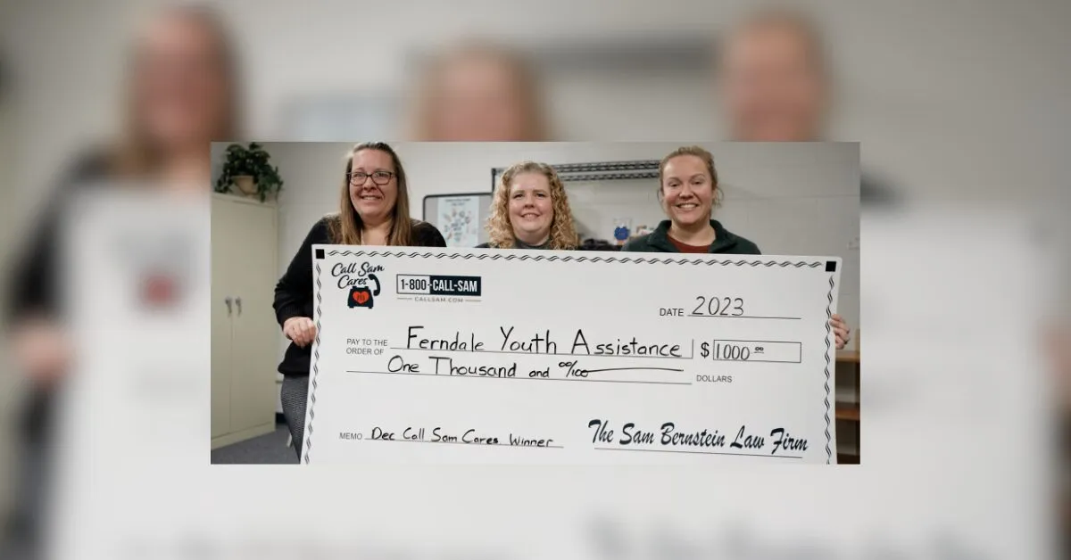 3 women holding large format check