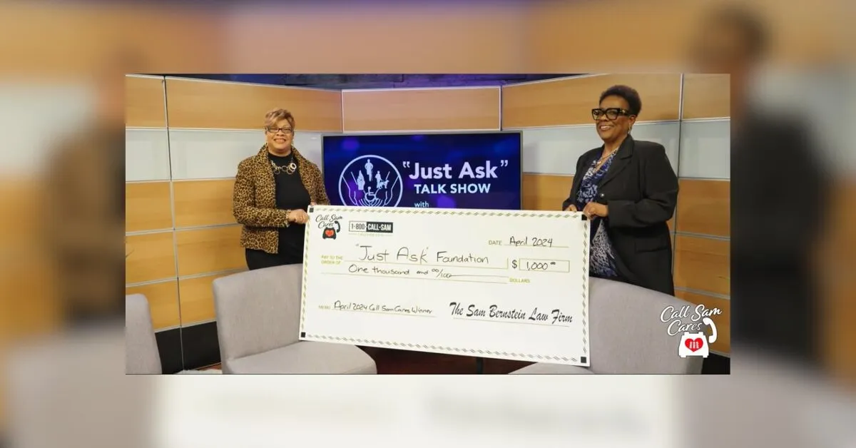 2 women holding large format check